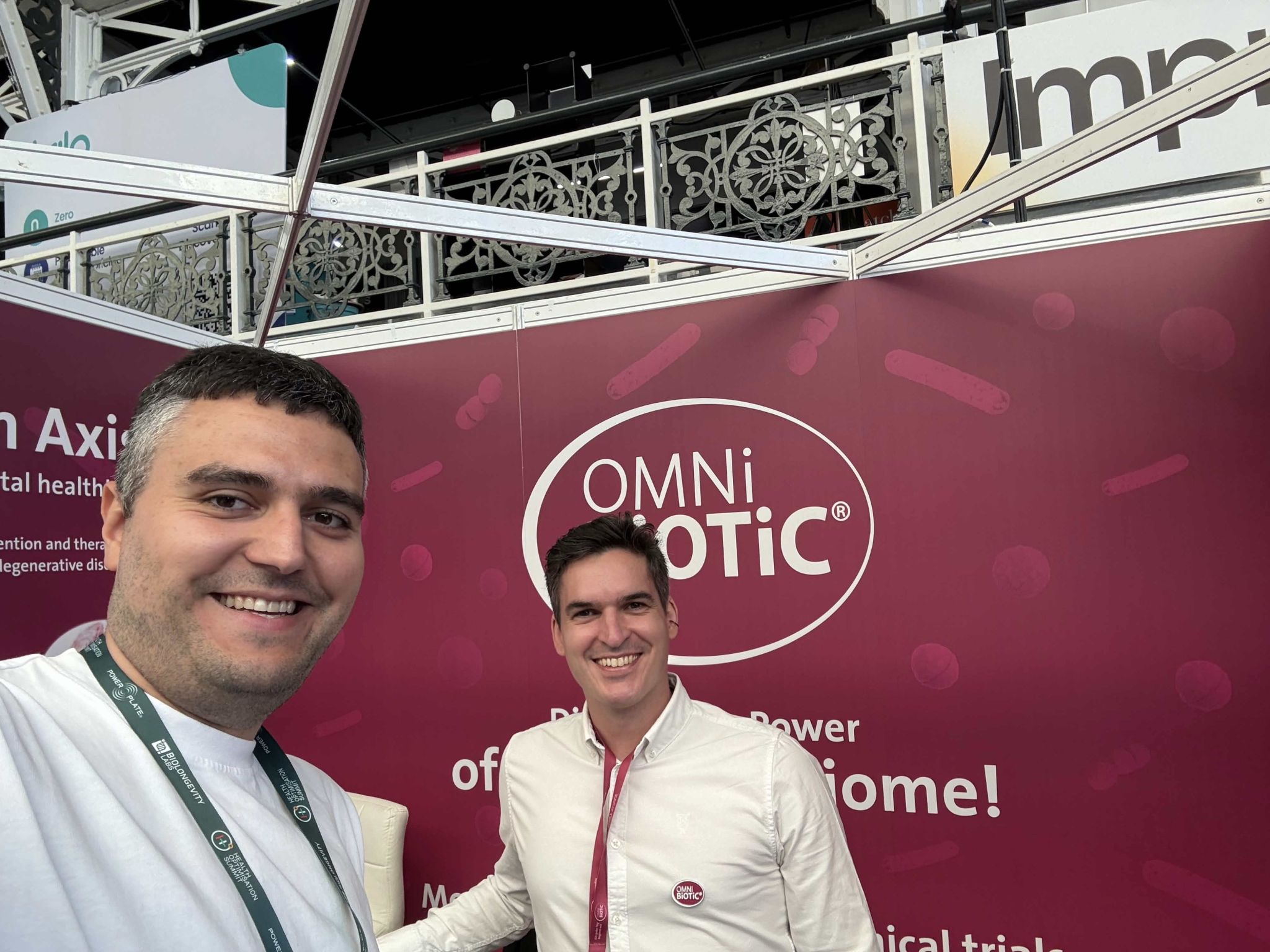 An xHeal team member with a visitor at the OMNI Biotic stand, on synbiotics and the microbiome